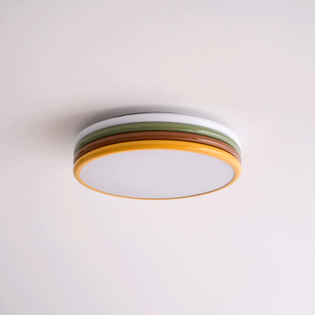 Unlit Clérachic ceiling light on a pale pink-white ceiling, its green and red-brown tiers above a frosted diffuser.