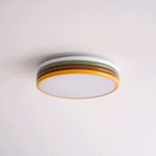 Unlit Clérachic ceiling light on a pale pink-white ceiling, its green and red-brown tiers above a frosted diffuser.