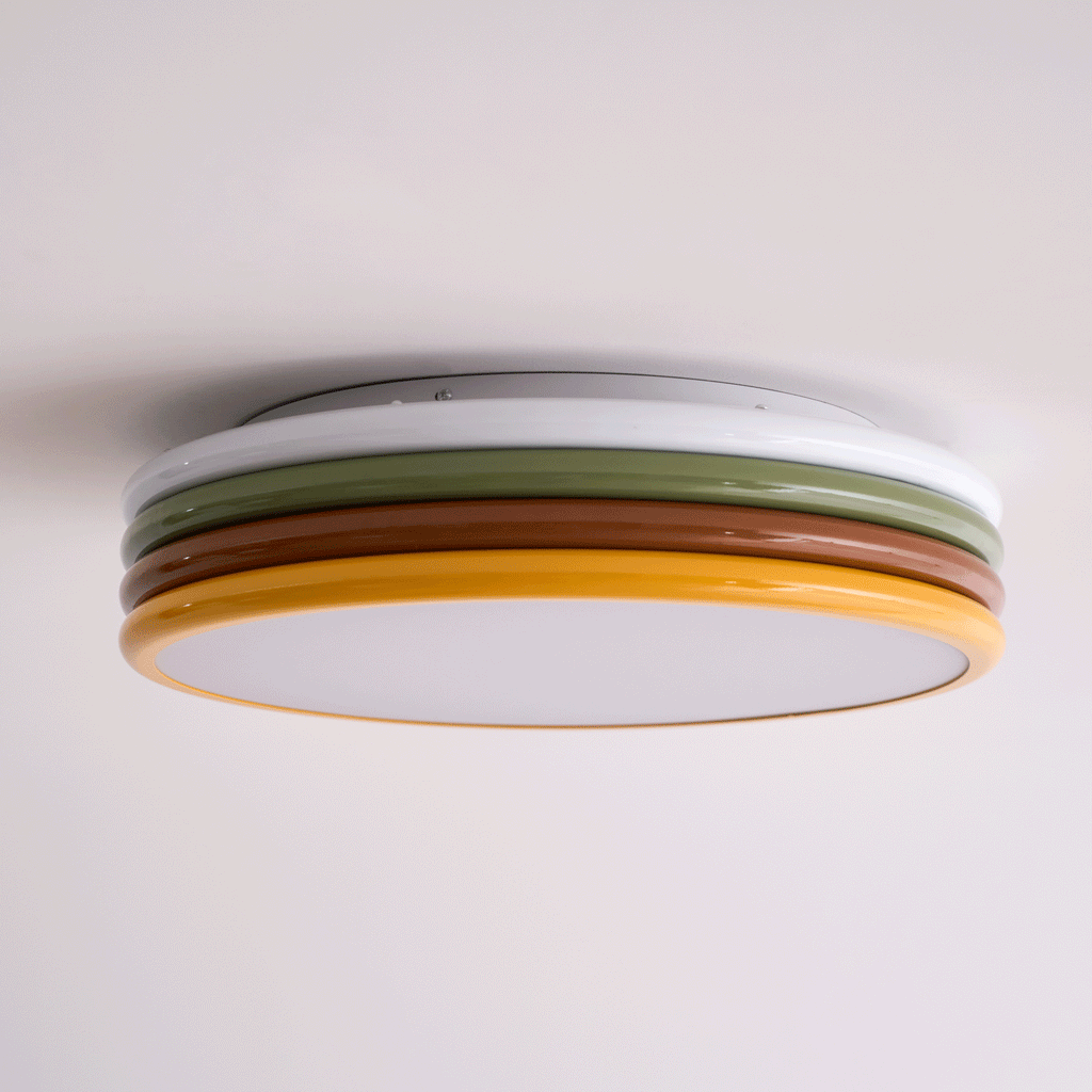 Low side view of this unlit Clérachic ceiling light, its canopy plate, four coloured rings and frosted diffuser all showing.