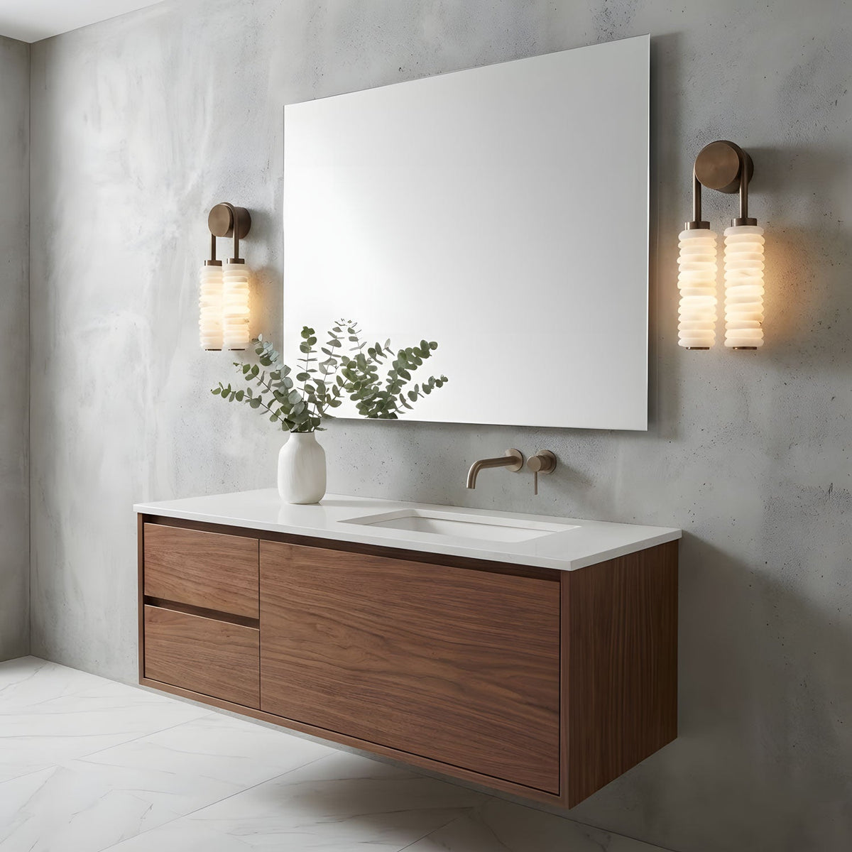 Two Clérachic sconces on a concrete-effect bathroom wall, flanking a large frameless mirror above a floating walnut vanity.