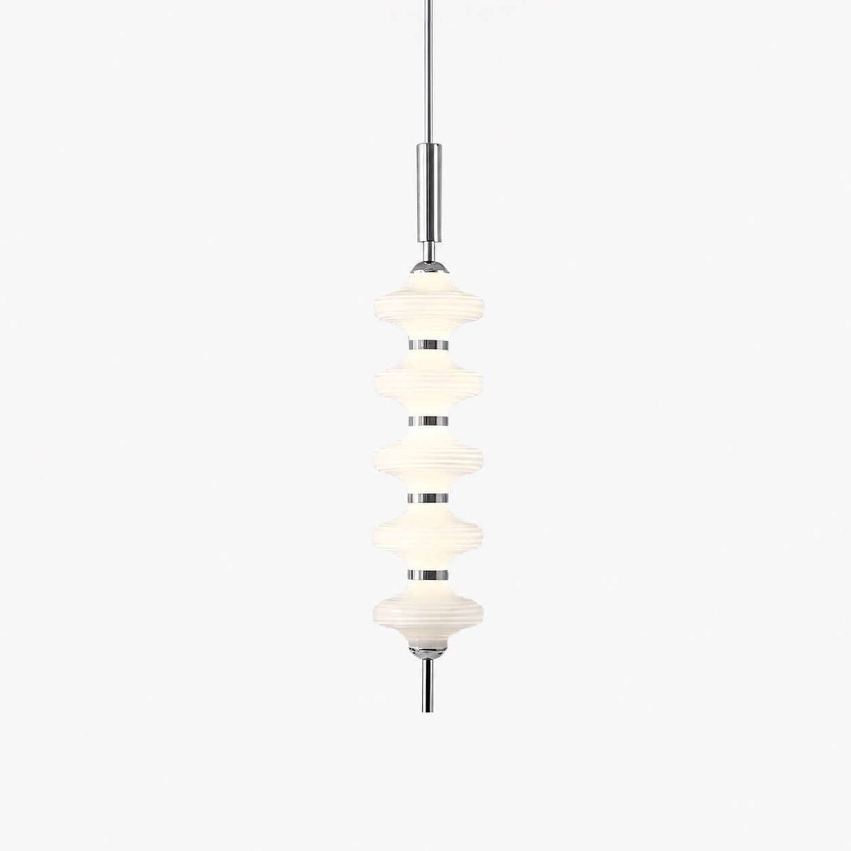 Chrome and white Clérachic pendant of five stacked ribbed glass discs on a slim rod, lit and hung on a plain white backdrop.