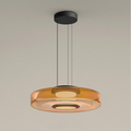 Clérachic Stacked Glass Disc Pendant Light in amber, a single tier lit from its central diffuser and hung on three black cables.
