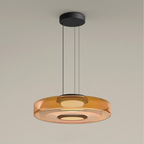 Clérachic Stacked Glass Disc Pendant Light in amber, a single tier lit from its central diffuser and hung on three black cables.