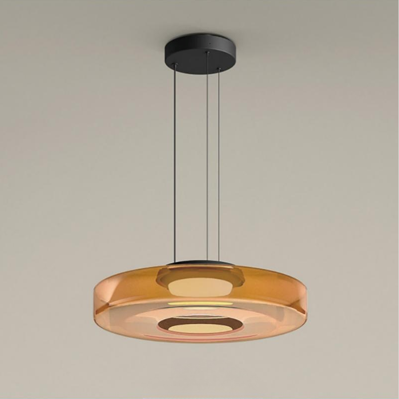 Clérachic Stacked Glass Disc Pendant Light in amber, a single tier lit from its central diffuser and hung on three black cables.