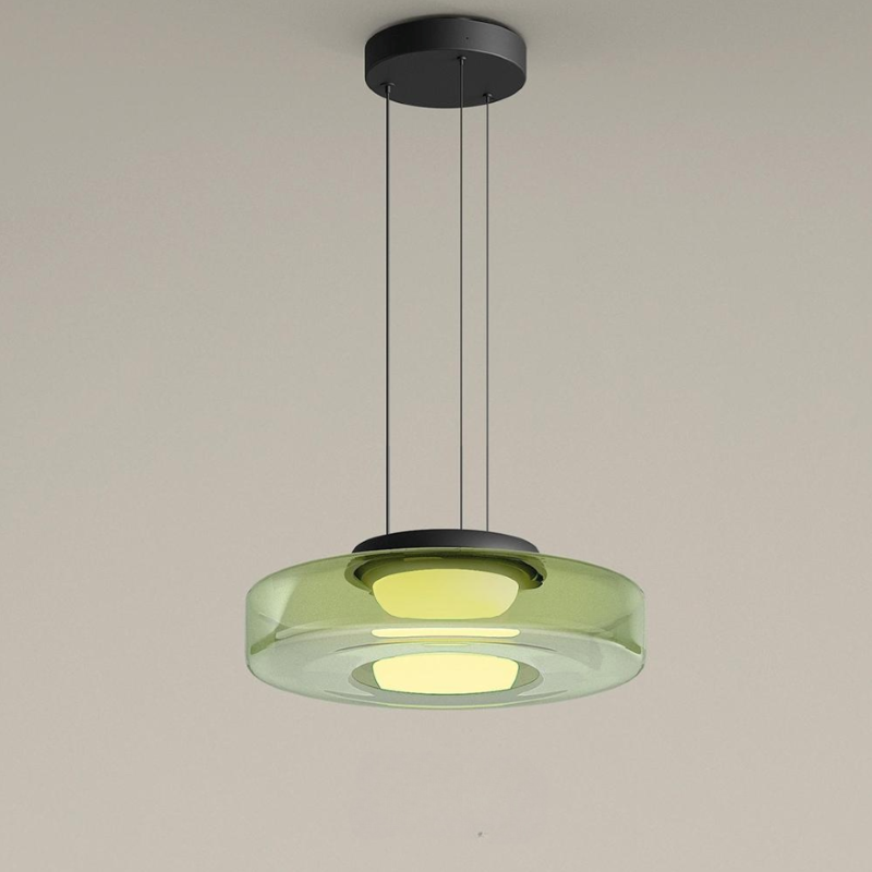 Clérachic Stacked Glass Disc Pendant Light in green, one tier glowing yellow-green beneath a shallow black ceiling canopy.