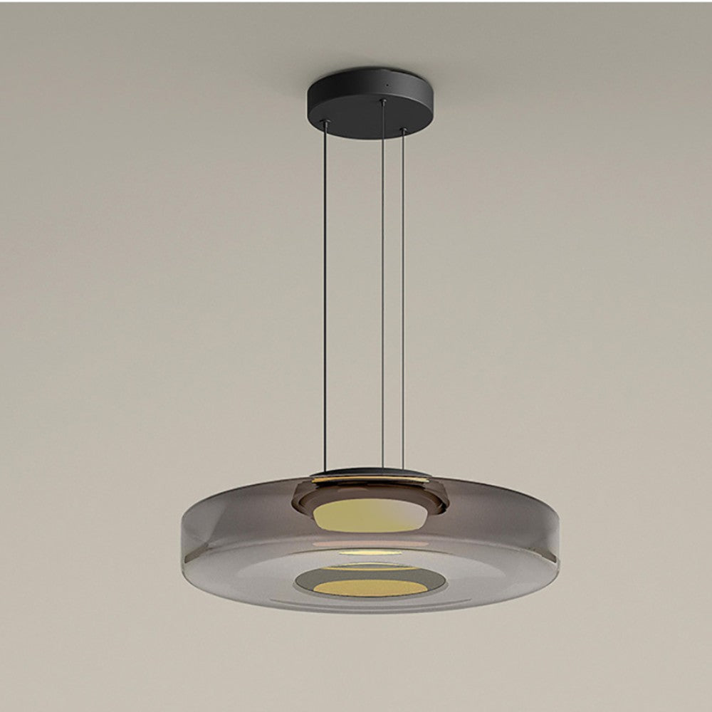Clérachic Stacked Glass Disc Pendant Light in Smoke Gray, one tier with a honey-warm diffuser pooling light at its centre.