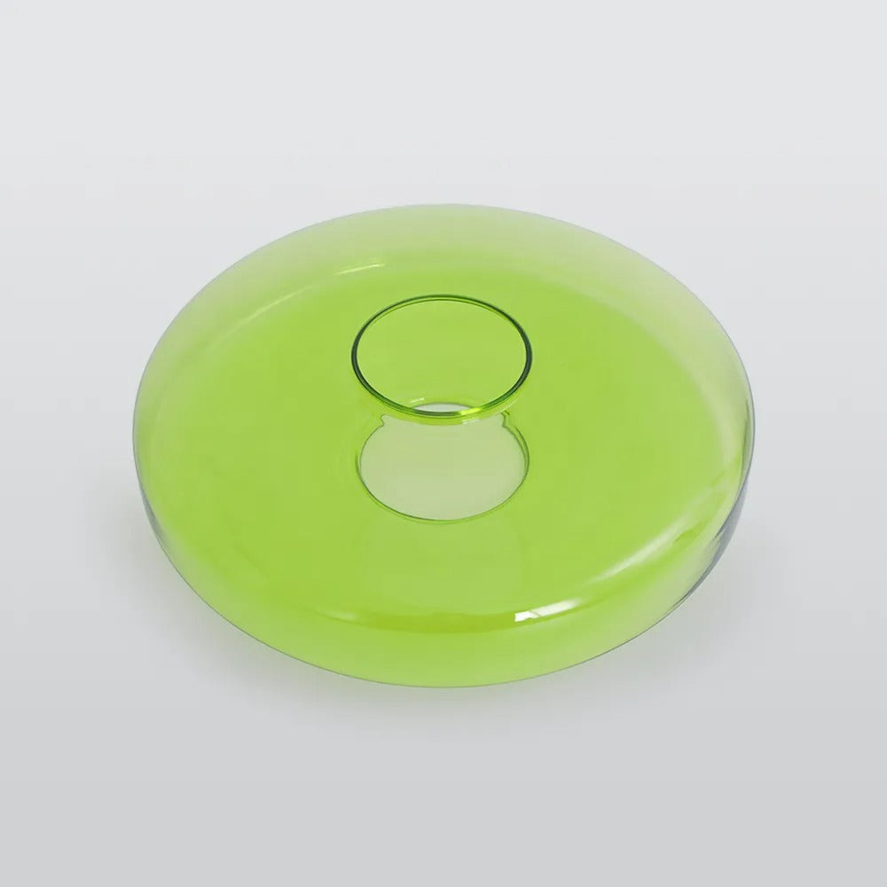 A single green glass tier from the Clérachic Stacked Glass Disc Pendant Light, off the fixture, showing its central fitting collar.
