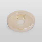 A deeper amber disc of the Clérachic Stacked Glass Disc Pendant Light, photographed alone to show the thick rolled rim bead.