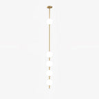 Five-globe Clérachic pendant on a white backdrop, with its slim brass column and round ceiling plate, and one globe set high on the rod.