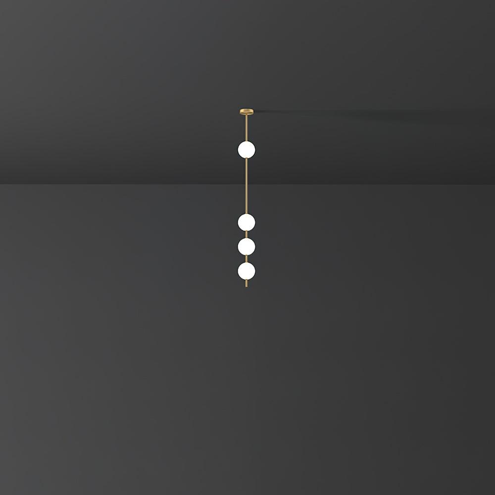 Small-scale view of a Clérachic pendant with four glowing globes on a brass column, set in a dark grey room.
