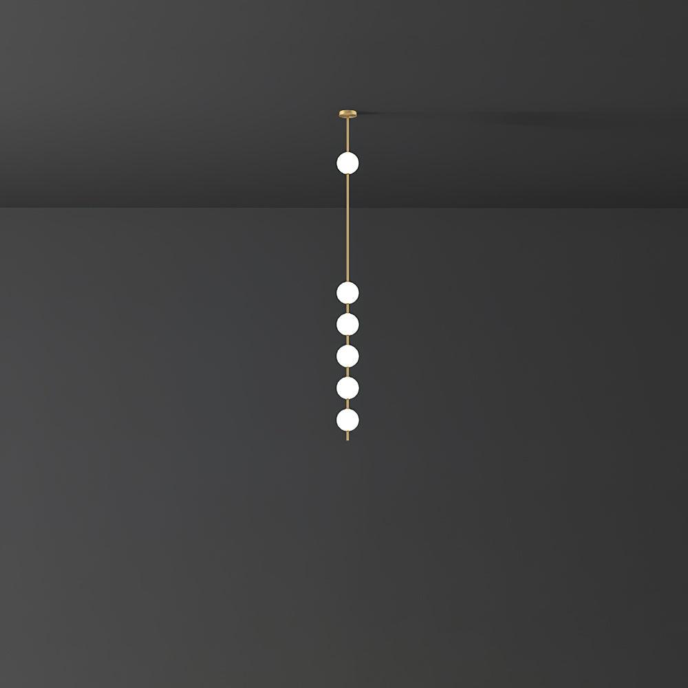 Clérachic pendant with six globes on a slender brass column, the group clustered low, against a dark wall.
