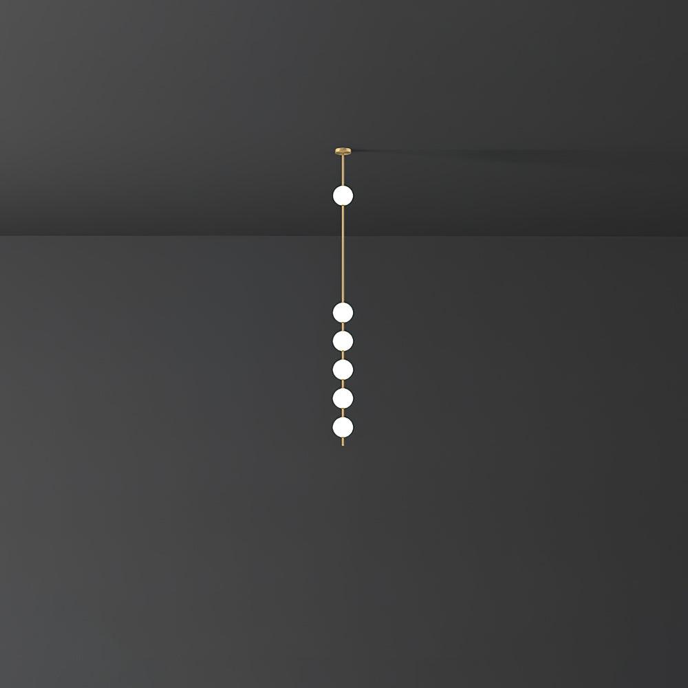 Clérachic pendant with six small opal globes in a tight group below one higher globe, against a dark grey backdrop.