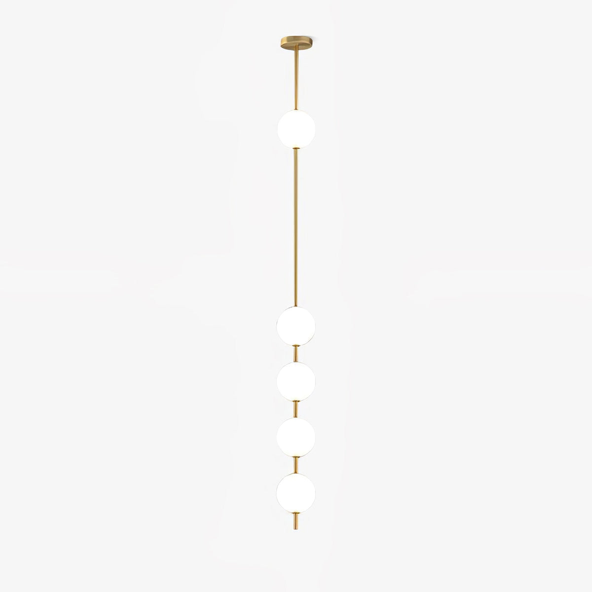 This Clérachic pendant on a pale backdrop, with five white globes down a slim brass column and a round brass ceiling plate.