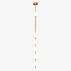 Six opal globes on a brass column from a Clérachic pendant, with a gloss brass ceiling plate on a pale grey backdrop.