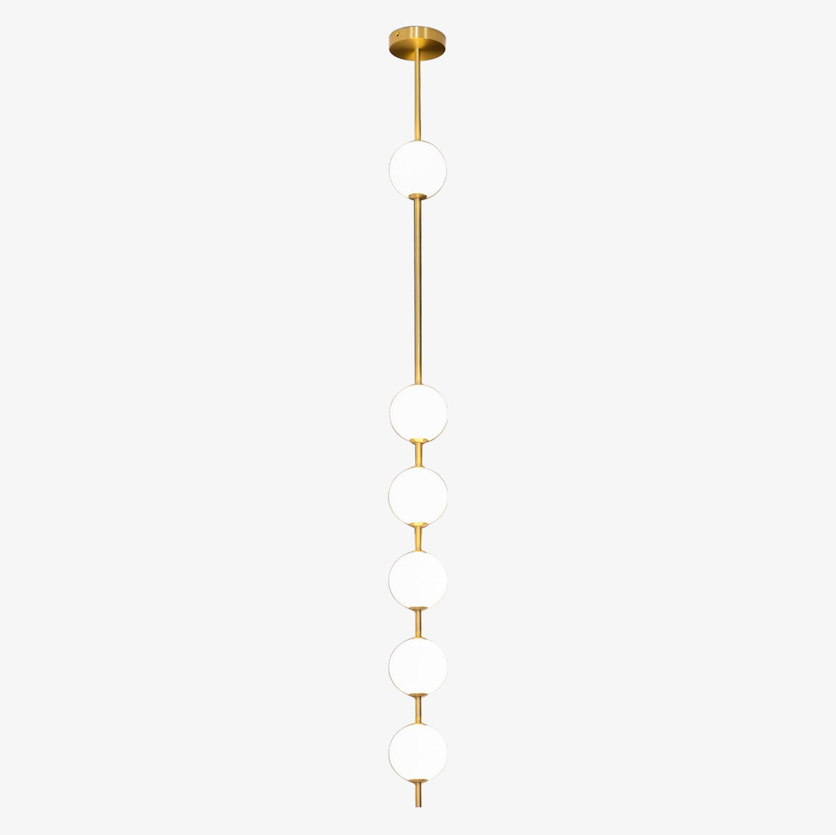 Six opal globes on a brass column from a Clérachic pendant, with a gloss brass ceiling plate on a pale grey backdrop.
