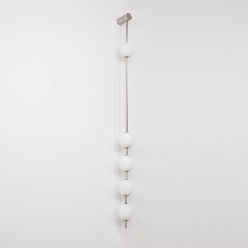 The Clérachic Stacked Globe Wall Sconce in brushed nickel, unlit, five globes shown at a slight angle.