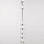 The Clérachic Stacked Globe Wall Sconce in brushed nickel, unlit, six globes shown full-length on white.