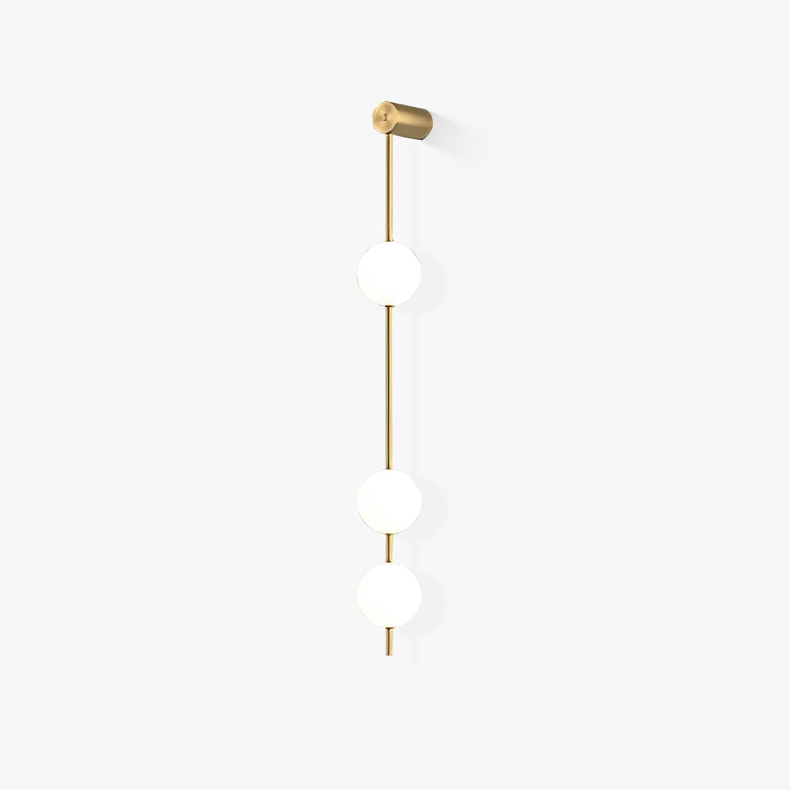 The Clérachic Stacked Globe Wall Sconce in brass, unlit, three globes photographed at a gentle angle.