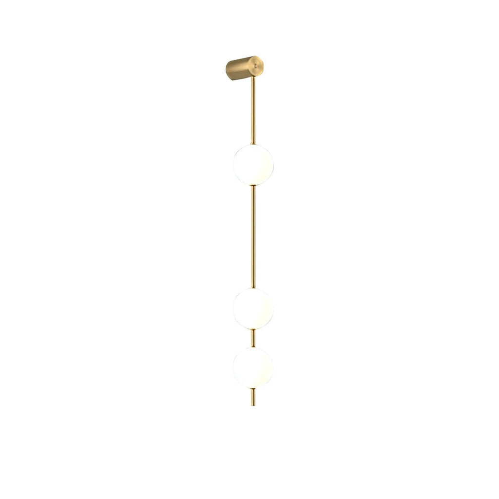 The Clérachic Stacked Globe Wall Sconce in brass, lit, three globes photographed square-on against white.