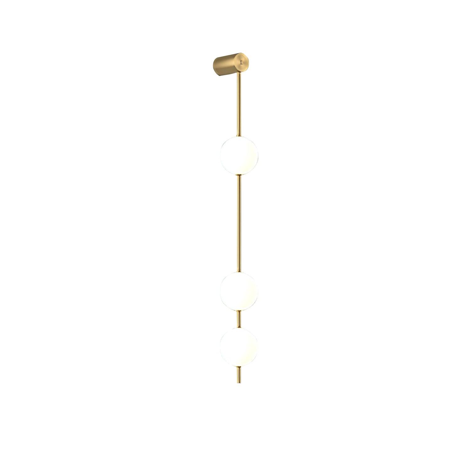 The Clérachic Stacked Globe Wall Sconce in brass, lit, three globes photographed square-on against white.
