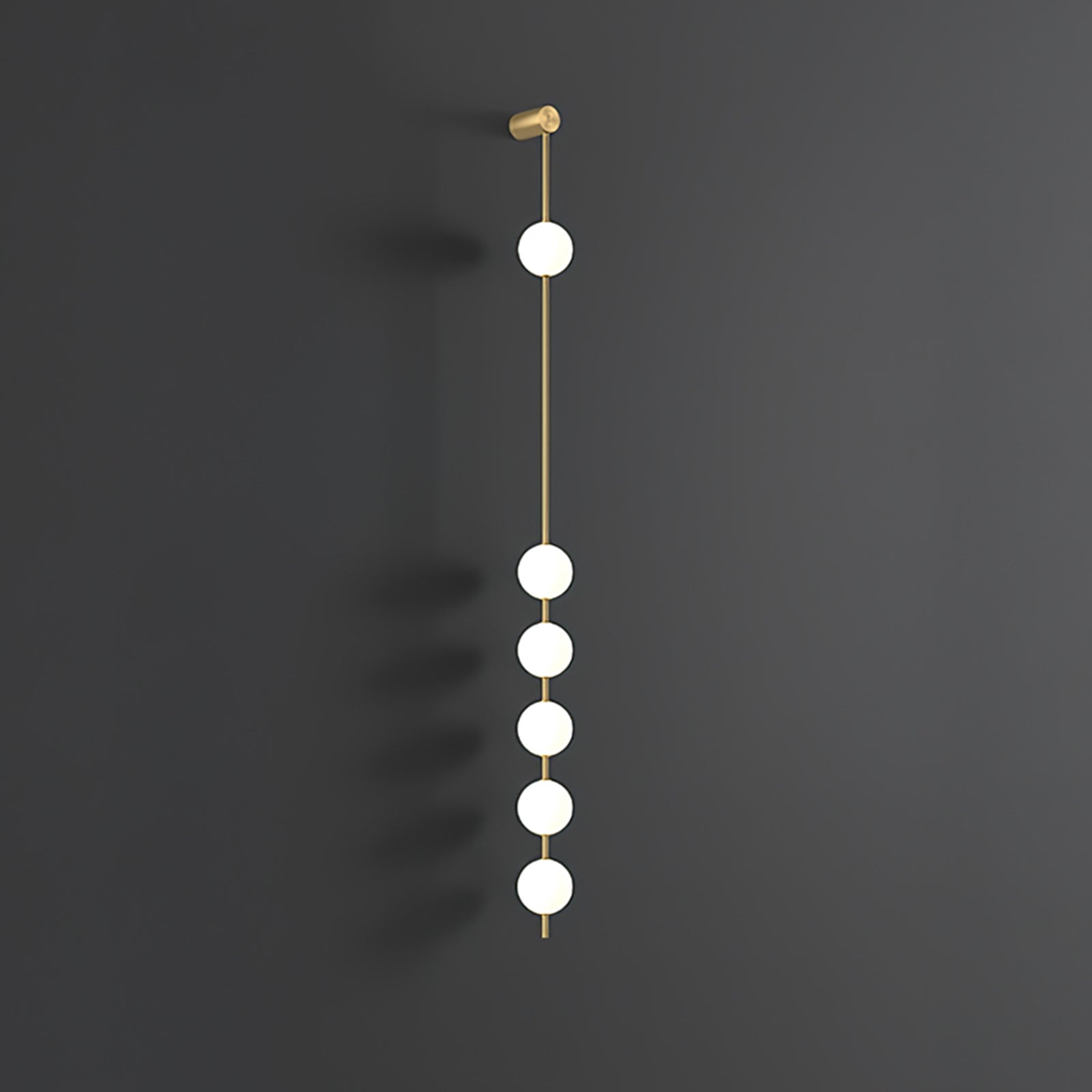 The Clérachic Stacked Globe Wall Sconce in brass, lit, six globes glowing the full drop on dark grey.