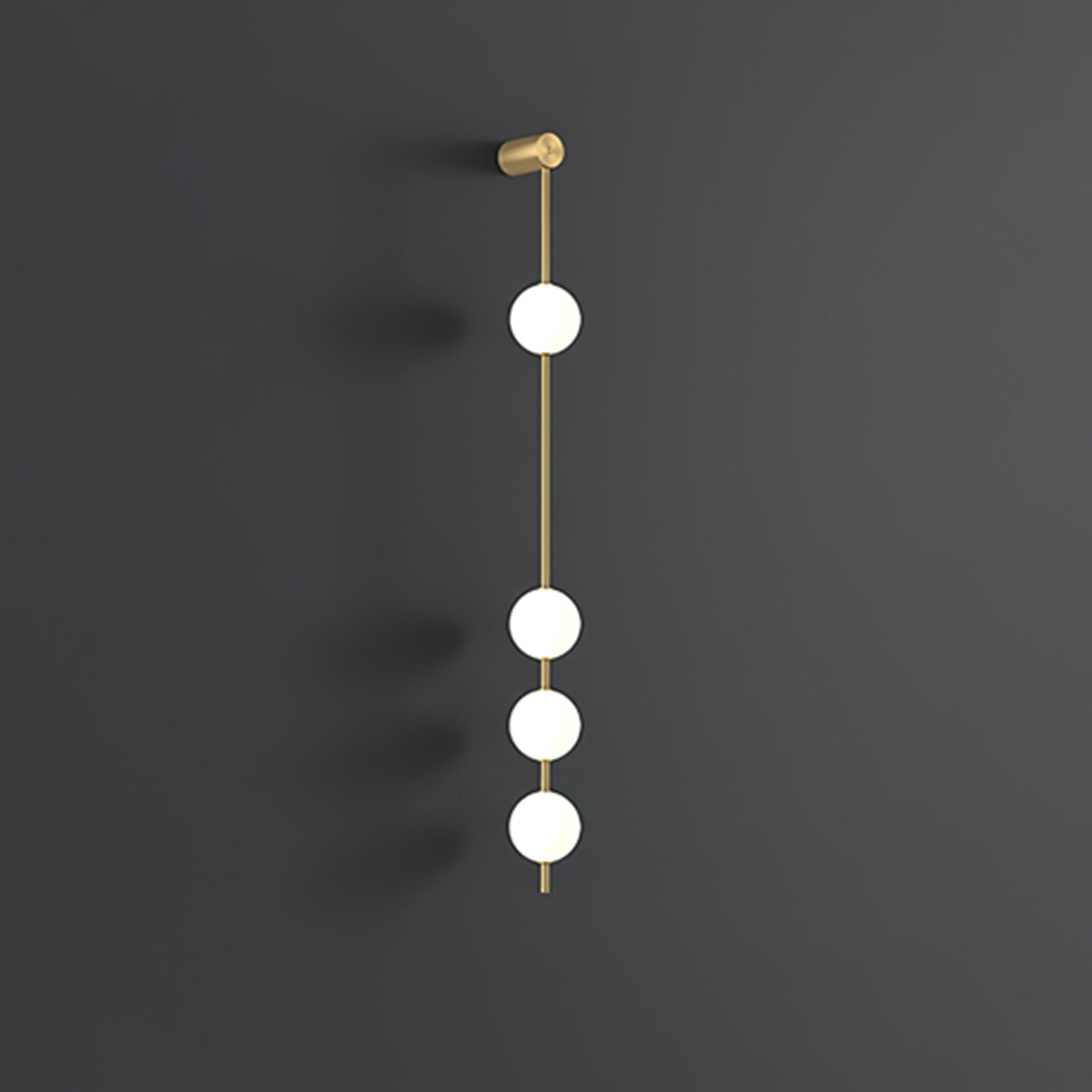 The Clérachic Stacked Globe Wall Sconce in brass, lit, five globes glowing against a dark grey studio wall.