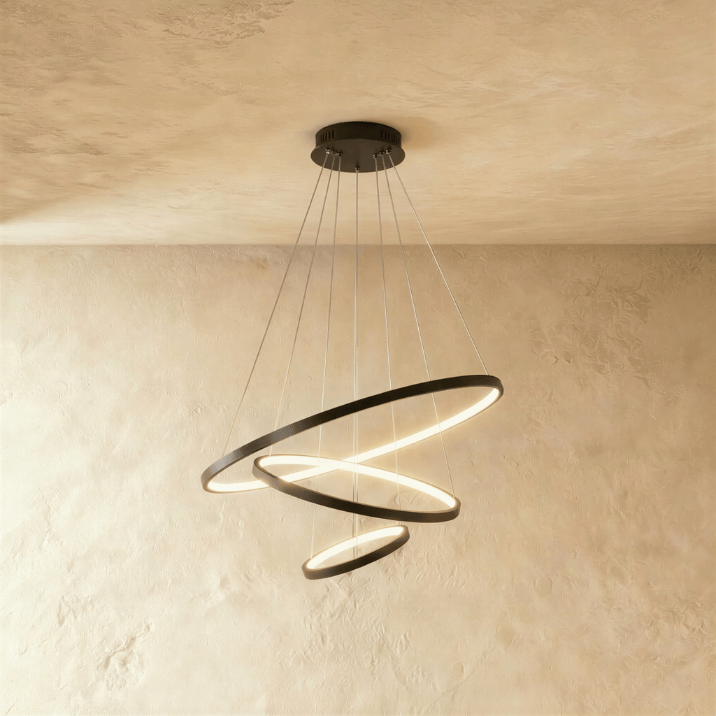 Three black rings cascade in a staggered spiral in this Clérachic chandelier, each glowing warm from below.