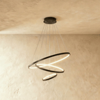 Three black rings cascade in a staggered spiral in this Clérachic chandelier, each glowing warm from below.
