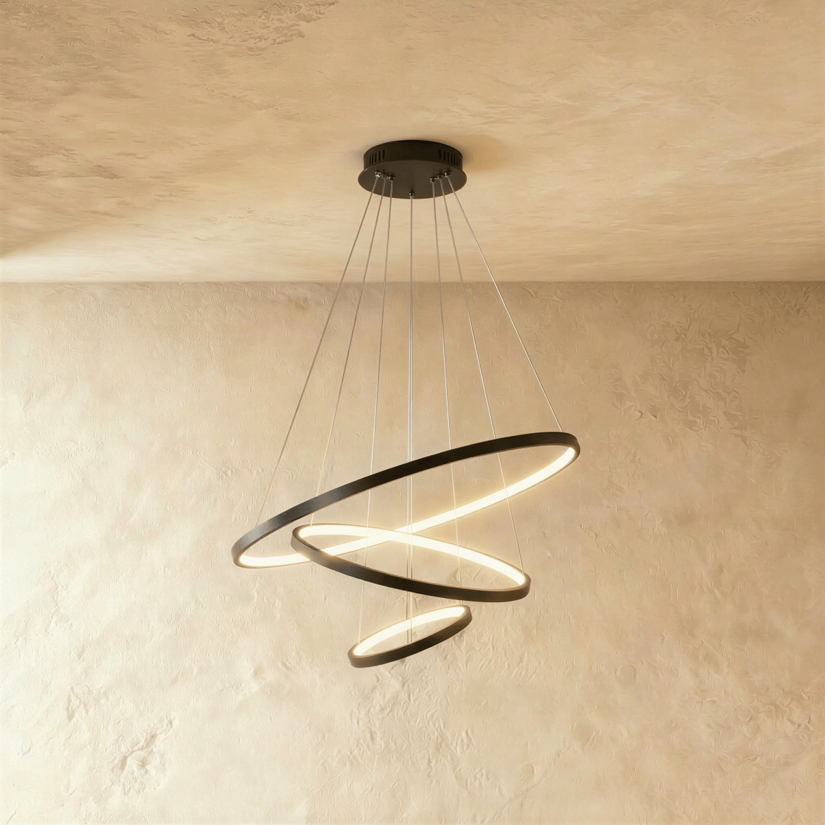 Three black rings cascade in a staggered spiral in this Clérachic chandelier, each glowing warm from below.