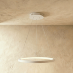 Clérachic's smallest white ring pendant hangs close to the ceiling, its edge glowing warm and soft.