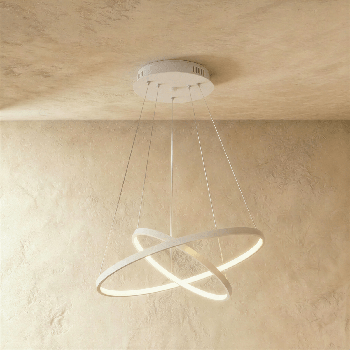 Clérachic's white two-ring chandelier shows its rings overlapping in an X, lit warm above a textured room.