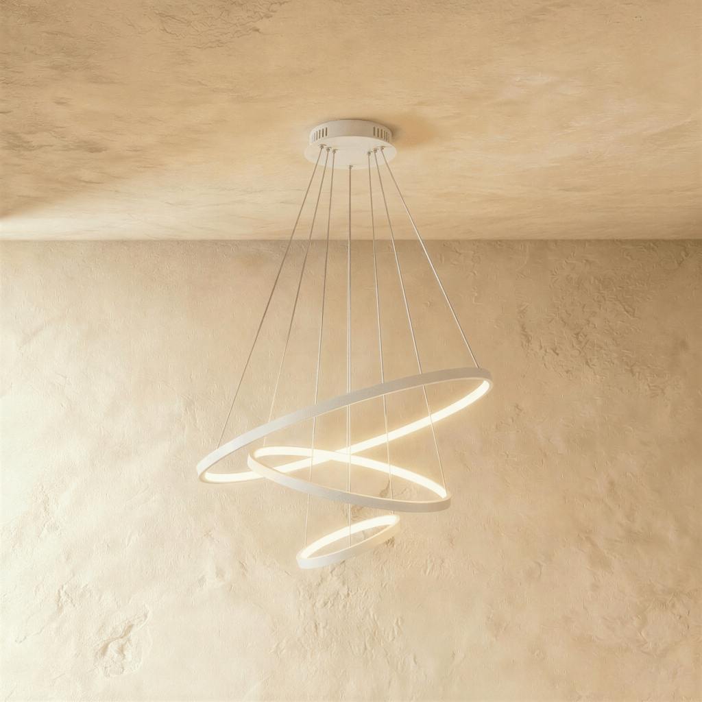 Three white rings cascade in a staggered spiral in this Clérachic chandelier, each glowing warm from below.