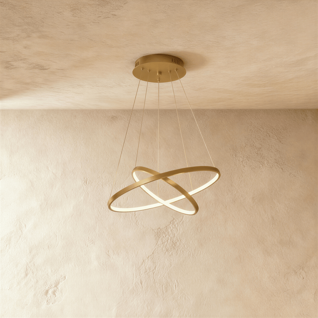 Clérachic's two-ring golden pendant crosses its rings like an X, suspended on five fine cables overhead.