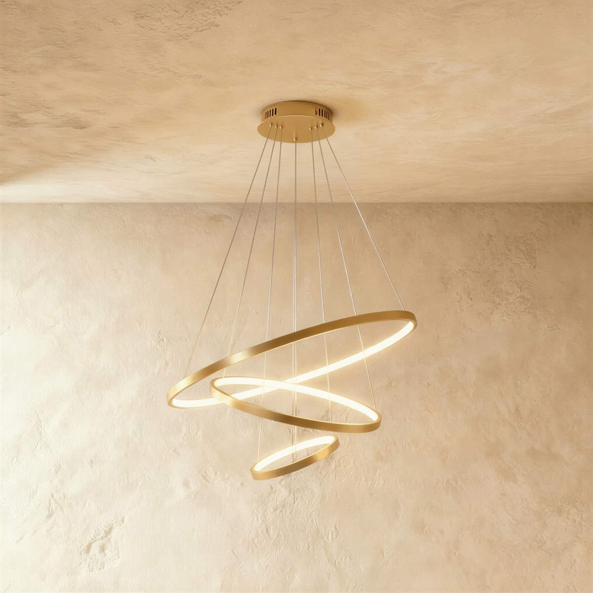 Three golden rings cascade in a staggered spiral in this Clérachic chandelier, each glowing warm from below.