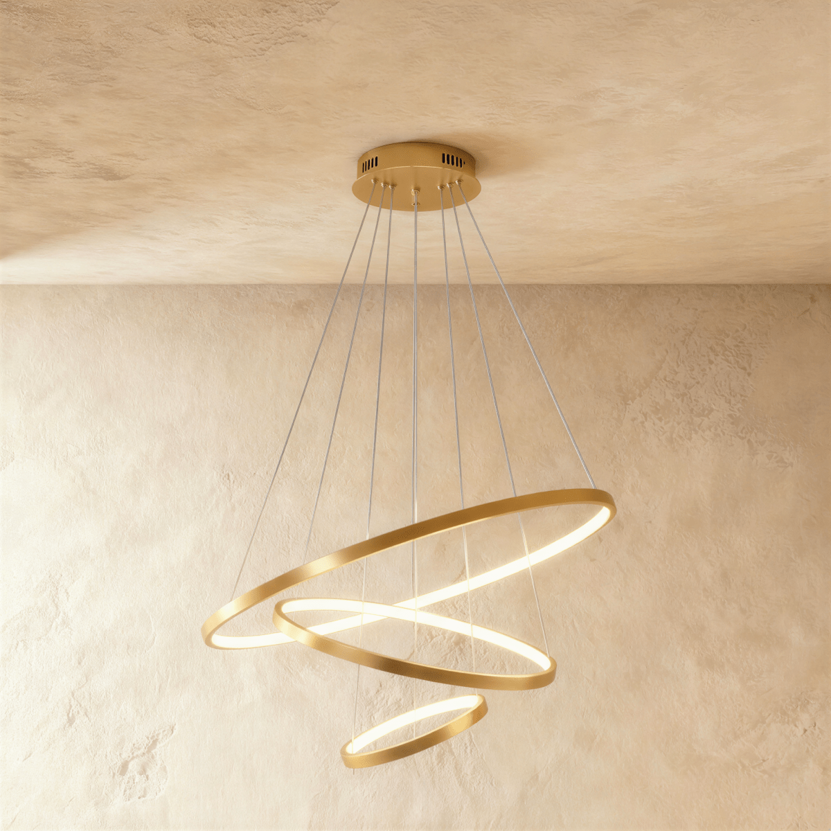Clérachic's golden three-ring chandelier spirals downward, the smallest ring glowing gently at its base.