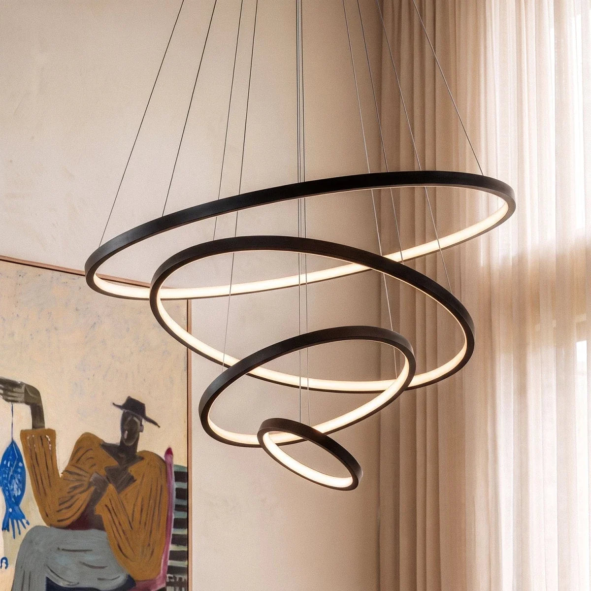 In this dining room, Clérachic's black cascading ring chandelier lights a live-edge table from a closer angle.