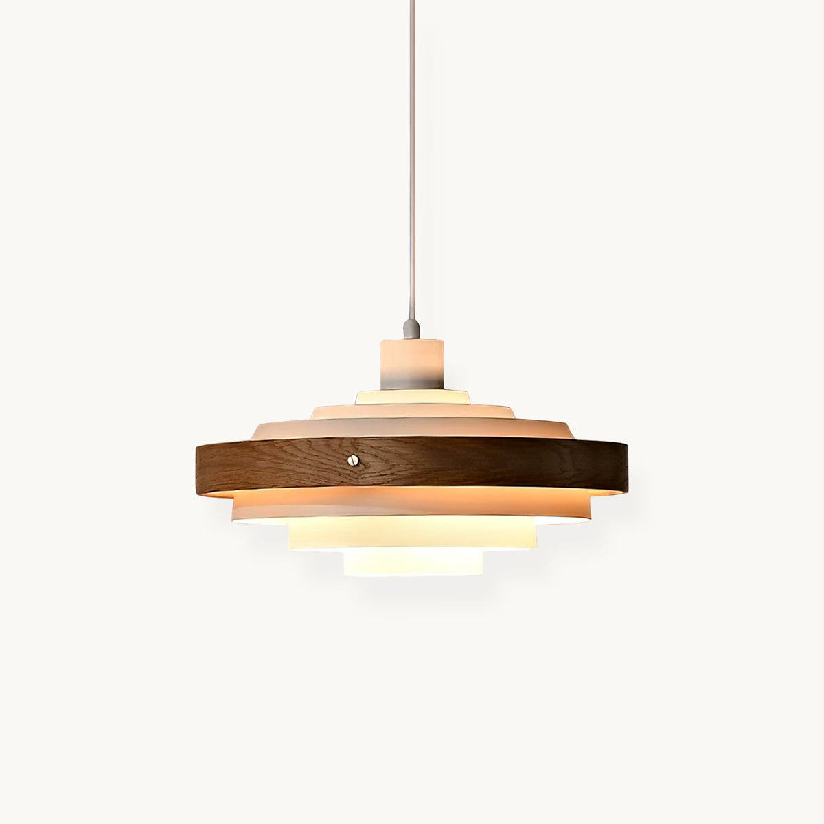 White and walnut Clérachic pendant with five stacked tiers, glowing from inside, on a cord against an off-white backdrop.