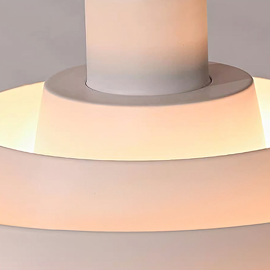 Close view of the white inner tiers of this Clérachic pendant, glowing warm around the central white stem.
