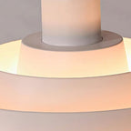 Close view of the white inner tiers of this Clérachic pendant, glowing warm around the central white stem.