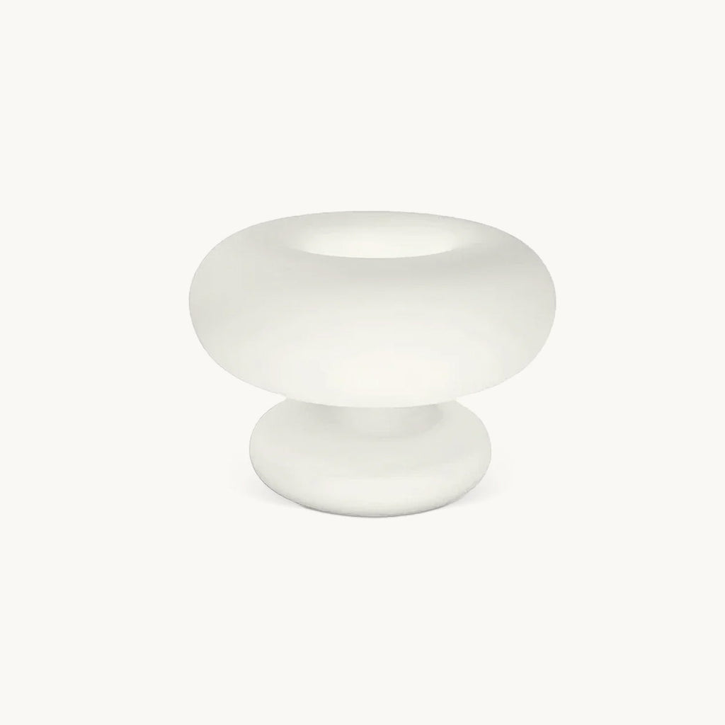 Frosted white glass Clérachic table lamp on a plain off-white backdrop, a wide donut-shaped shade resting on a rounded base.