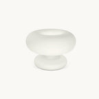 Frosted white glass Clérachic table lamp on a plain off-white backdrop, a wide donut-shaped shade resting on a rounded base.