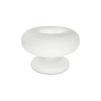 Matt white frosted glass Clérachic donut lamp on a white background, shot from slightly above with its open ring top in view.