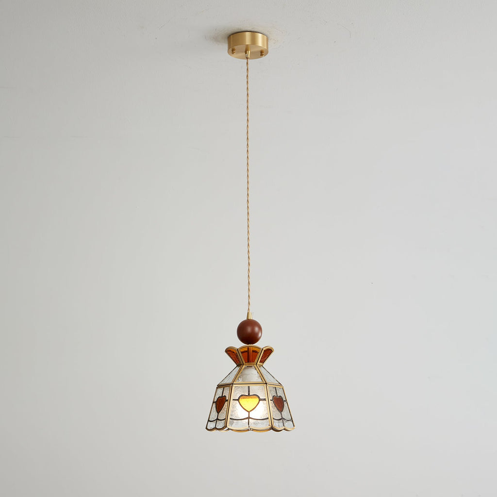 Small Clérachic heart-panel pendant hanging from a brass ceiling canopy on a long cord, shown against a pale wall.