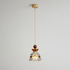 Small Clérachic heart-panel pendant hanging from a brass ceiling canopy on a long cord, shown against a pale wall.