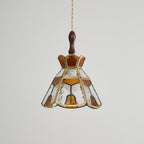 Unlit Clérachic pendant with a stepped amber crown, clear rippled glass and amber teardrop panels in brass came.