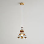 Small Clérachic stepped-crown pendant on a long cord from a brass ceiling canopy, shown against a pale wall.