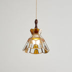 Clérachic stepped-crown pendant, lit, with amber panels and clear rippled glass, photographed against a pale backdrop.