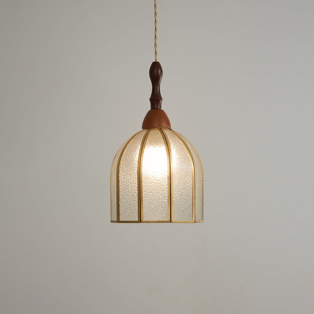 Clérachic domed pendant seen from slightly below, its brass ribs and open base visible beneath the lit glass.