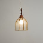 Clérachic domed pendant seen from slightly below, its brass ribs and open base visible beneath the lit glass.