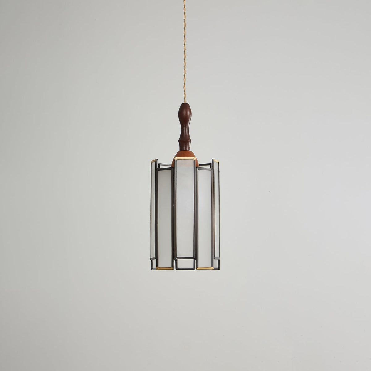 Unlit Clérachic pendant with a frosted glass shade in a slim dark frame, a wooden cap and a turned finial.